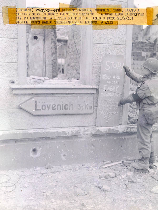 [U.S. Signal Corps Photo: MP Robert Fleming of the 407th Infantry Regiment, 102nd Infantry Division, Kofferen, Germany, February 1945]