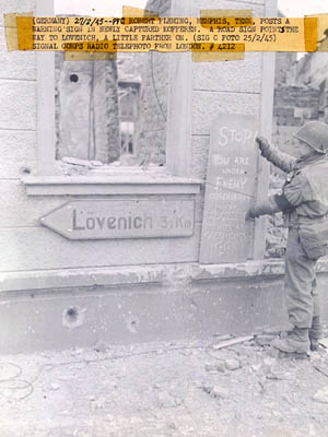 [MP Robert Fleming of the 407th Infantry Regiment, 102nd Infantry Division in Kofferen, Germany; U.S. Signal Corps Photo]